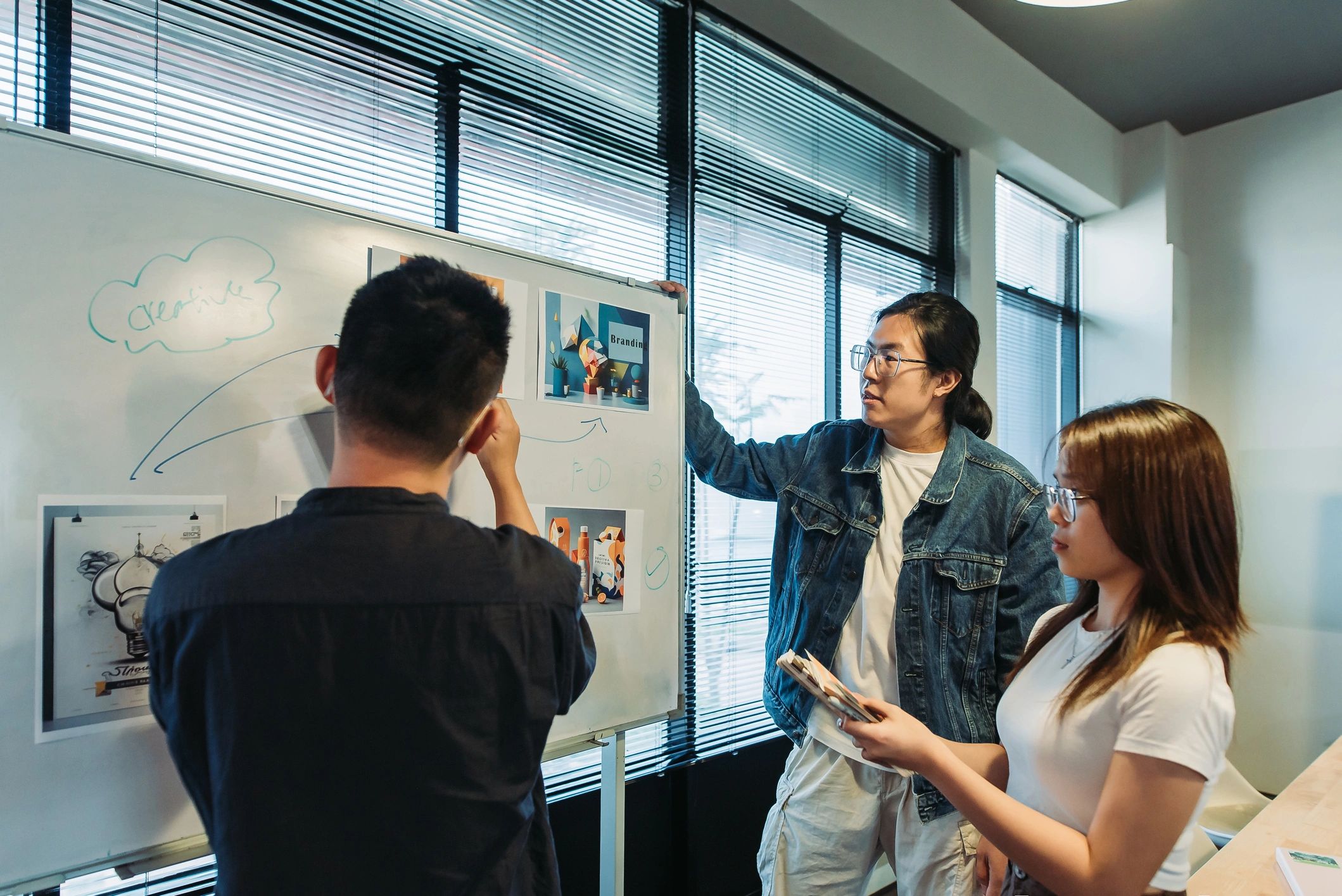 Team mapping business processes on a whiteboard in a conference room